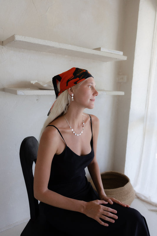 Women dressed fashion forward/formal, wearing silver star jewellery earrings and necklace